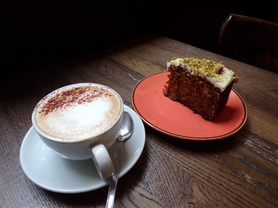 Coffee and a slice of cake on the table at Garrick's Head